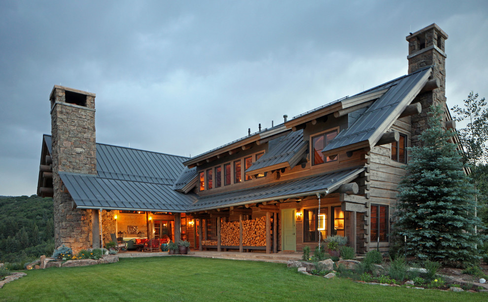Inspiration for a large rustic two floor house exterior in Denver.