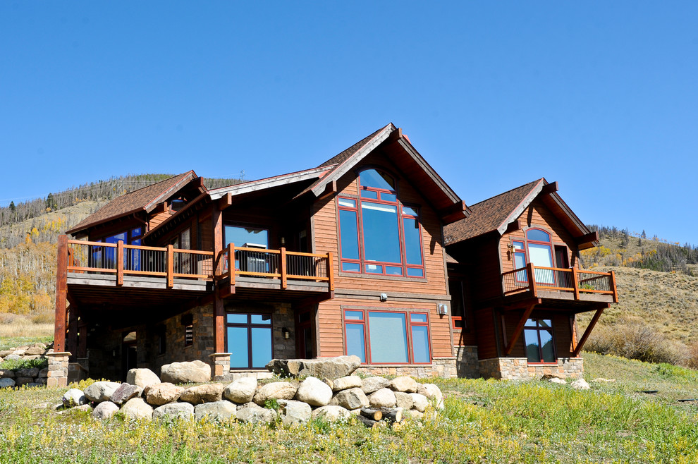 Large mountain style brown two-story mixed siding exterior home photo in Denver with a shingle roof