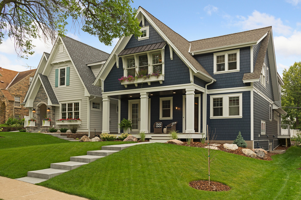 Mid-sized traditional blue wood house exterior idea in Minneapolis with a shingle roof