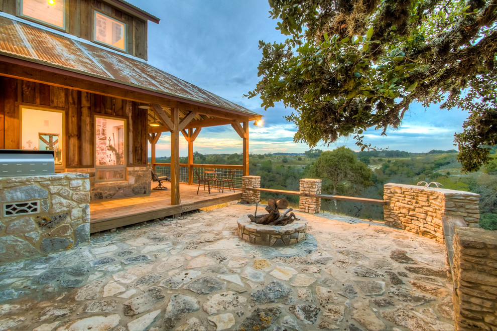 Mid-sized mountain style brown two-story wood gable roof photo in Austin