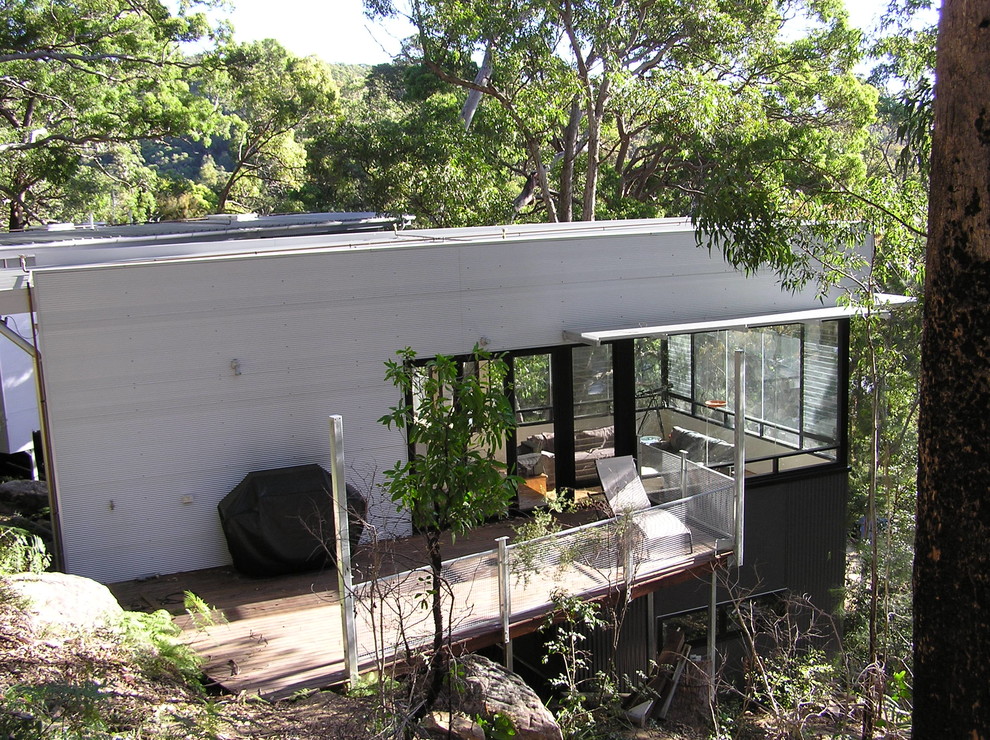 Example of a trendy metal exterior home design in Sydney