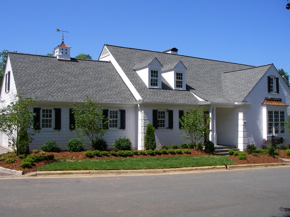 Mid-sized traditional white two-story vinyl gable roof idea in Other