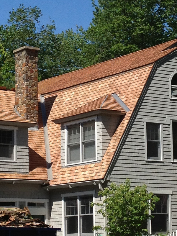 Inspiration for a large rustic gray two-story wood house exterior remodel in Boston with a shingle roof