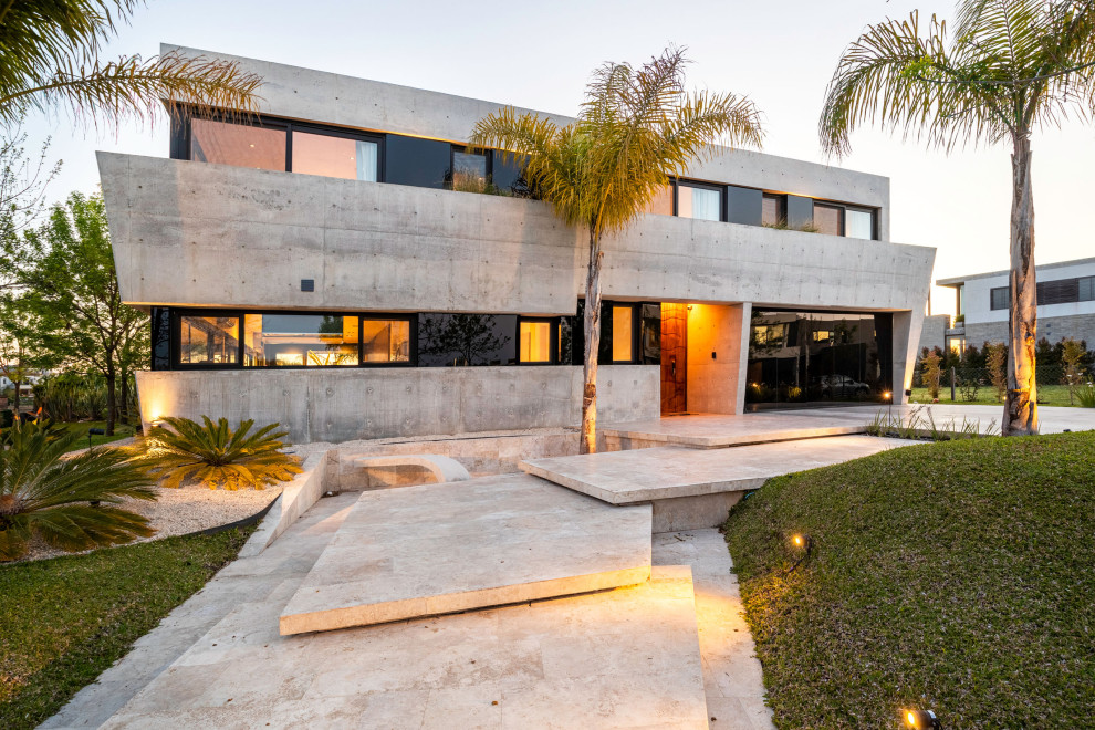 Inspiration for a large industrial gray two-story concrete exterior home remodel in Miami