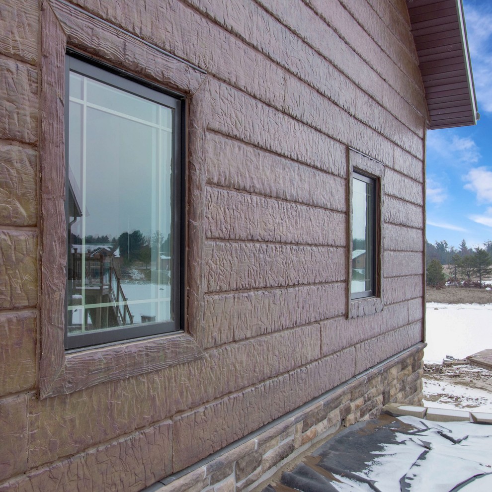 Mountain style brown concrete house exterior photo in Other