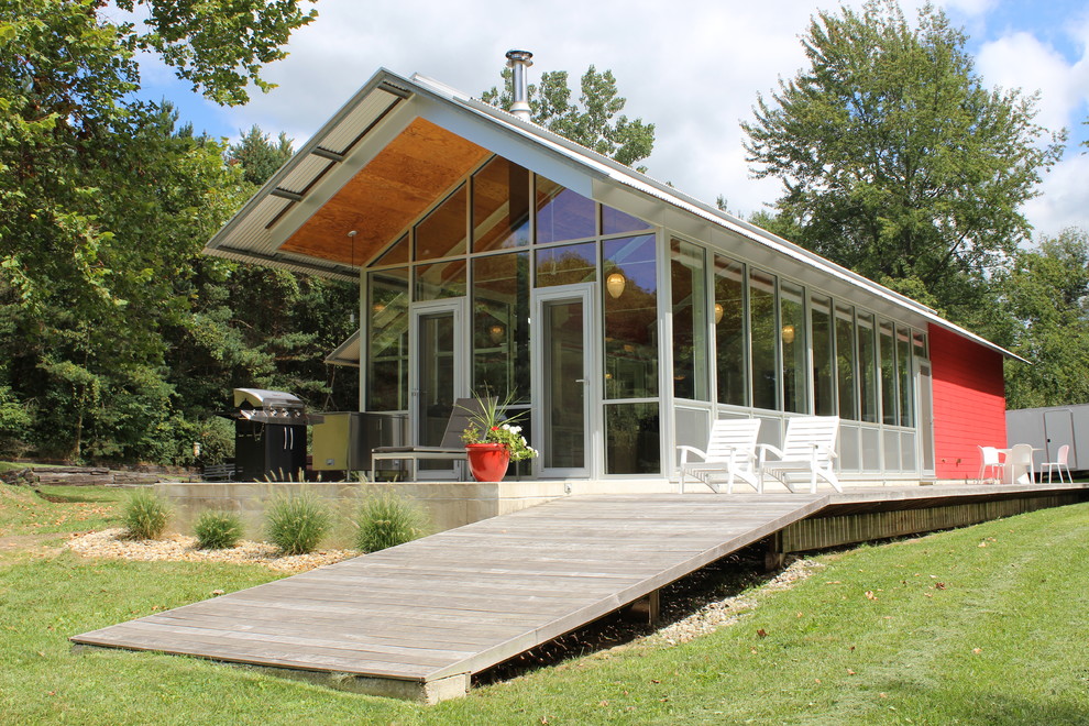 This is an example of a small and red modern glass house exterior in Chicago.