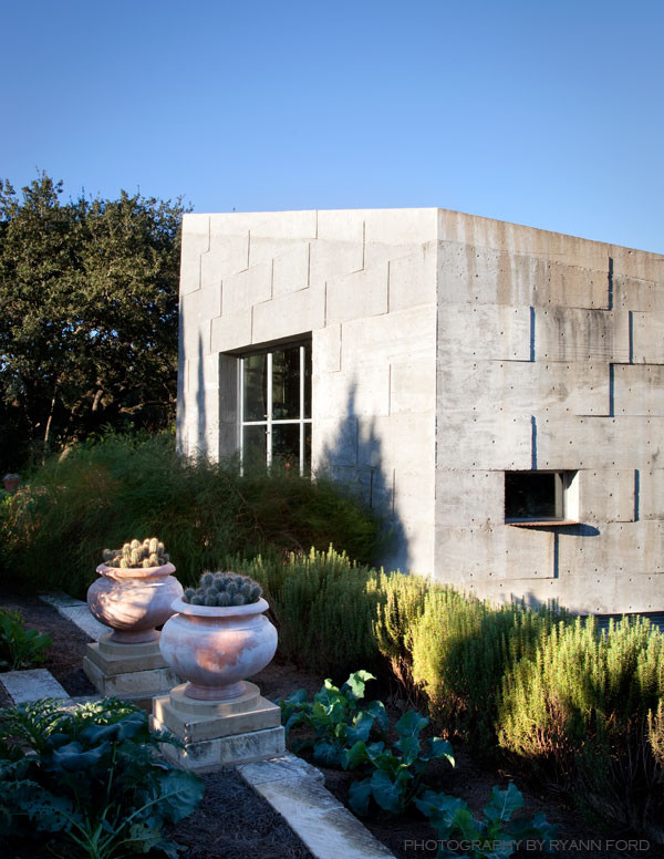 Small urban gray one-story concrete exterior home photo in Austin