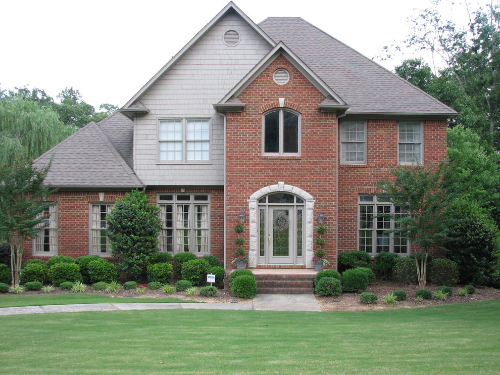 Example of a mid-sized classic red two-story brick exterior home design in Birmingham