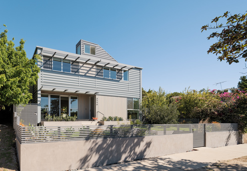 Inspiration for a large contemporary gray two-story mixed siding exterior home remodel in Los Angeles with a green roof