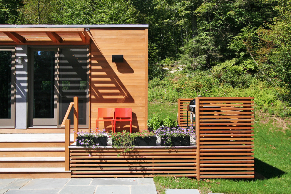 Inspiration for a small contemporary brown one-story wood exterior home remodel in New York
