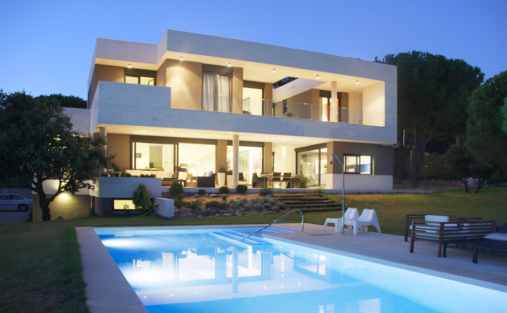 White contemporary two floor house exterior in Madrid with stone cladding.