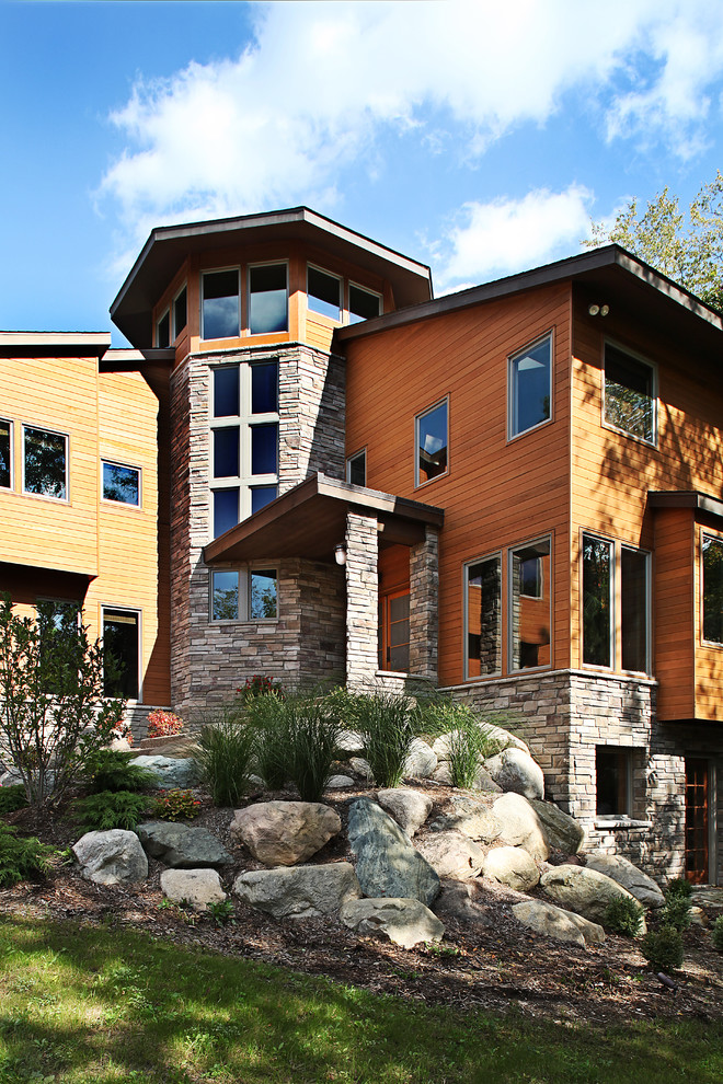 This is an example of a contemporary house exterior in Detroit with wood cladding.