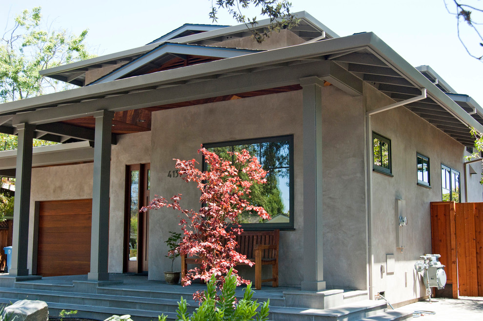Photo of a large and gey contemporary two floor render house exterior in San Francisco with a hip roof.