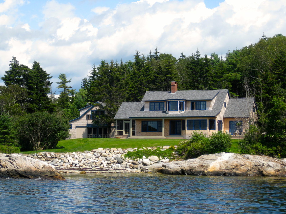 Example of a large beach style beige two-story wood exterior home design in Portland Maine with a shingle roof