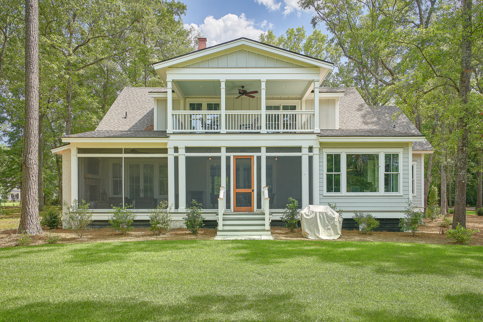 Photo of a large and gey nautical house exterior in Charleston with three floors, a shingle roof and wood cladding.