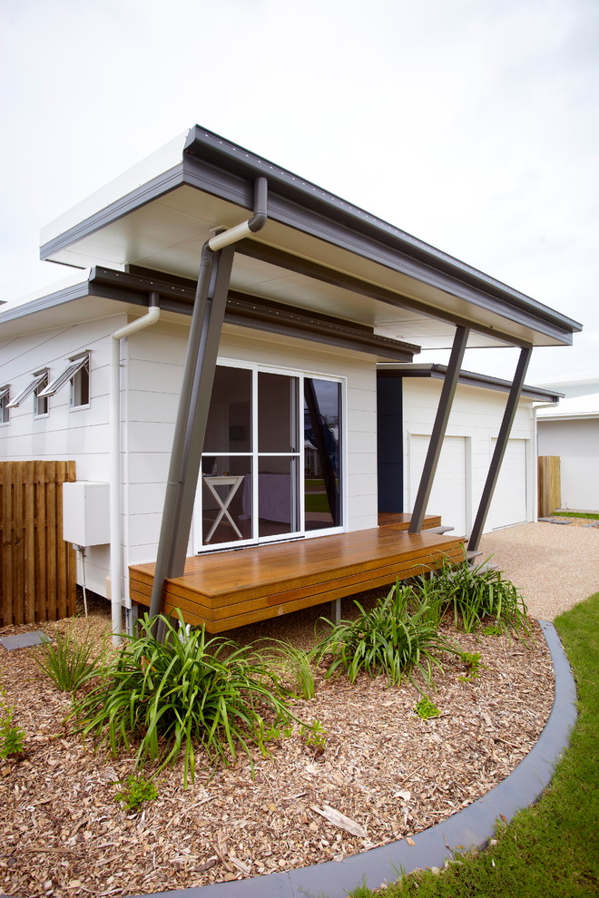 Design ideas for a white beach style house exterior in Brisbane.