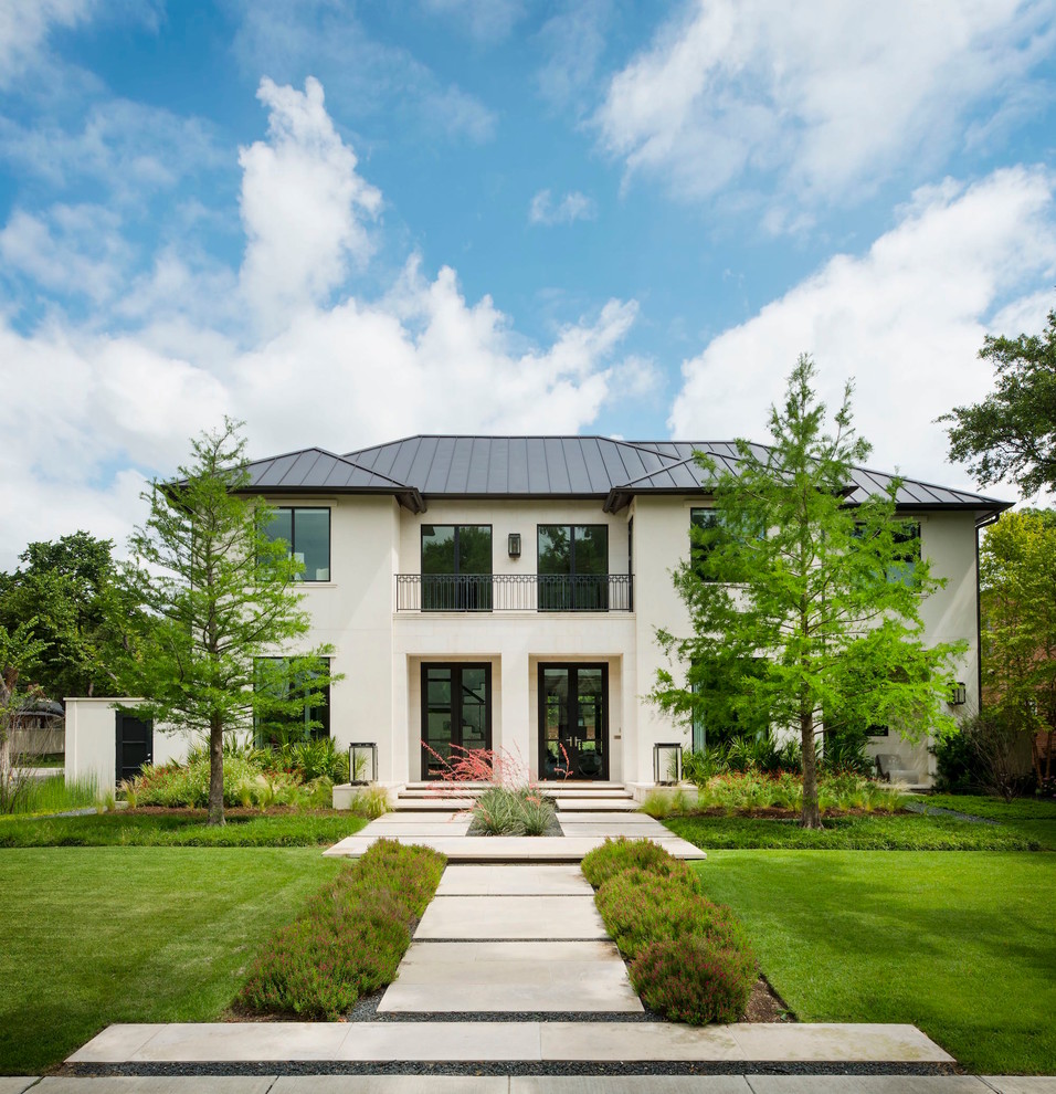 Transitional white two-story stone gable roof idea in Dallas