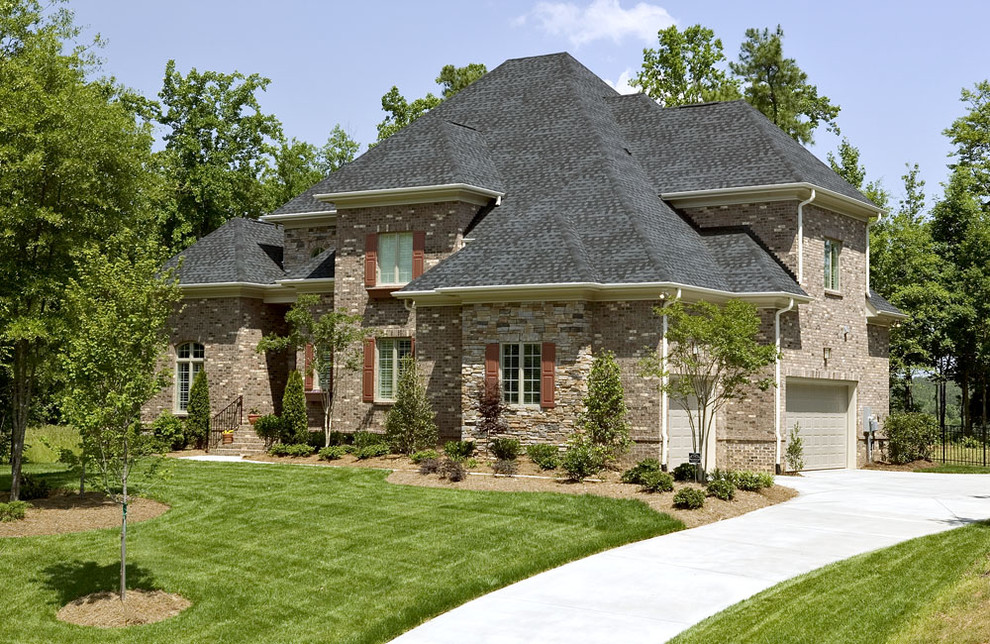 Example of a trendy brick exterior home design in Charlotte