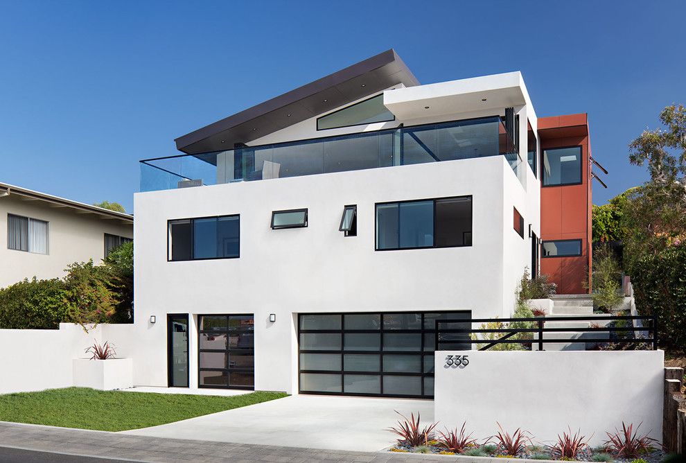 White contemporary house exterior in San Diego with three floors and a lean-to roof.