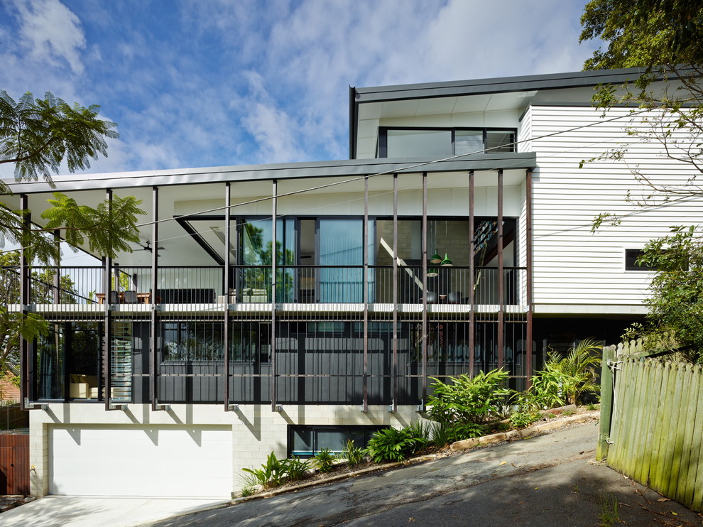 Design ideas for a large contemporary three-storey exterior in Brisbane with a shed roof.