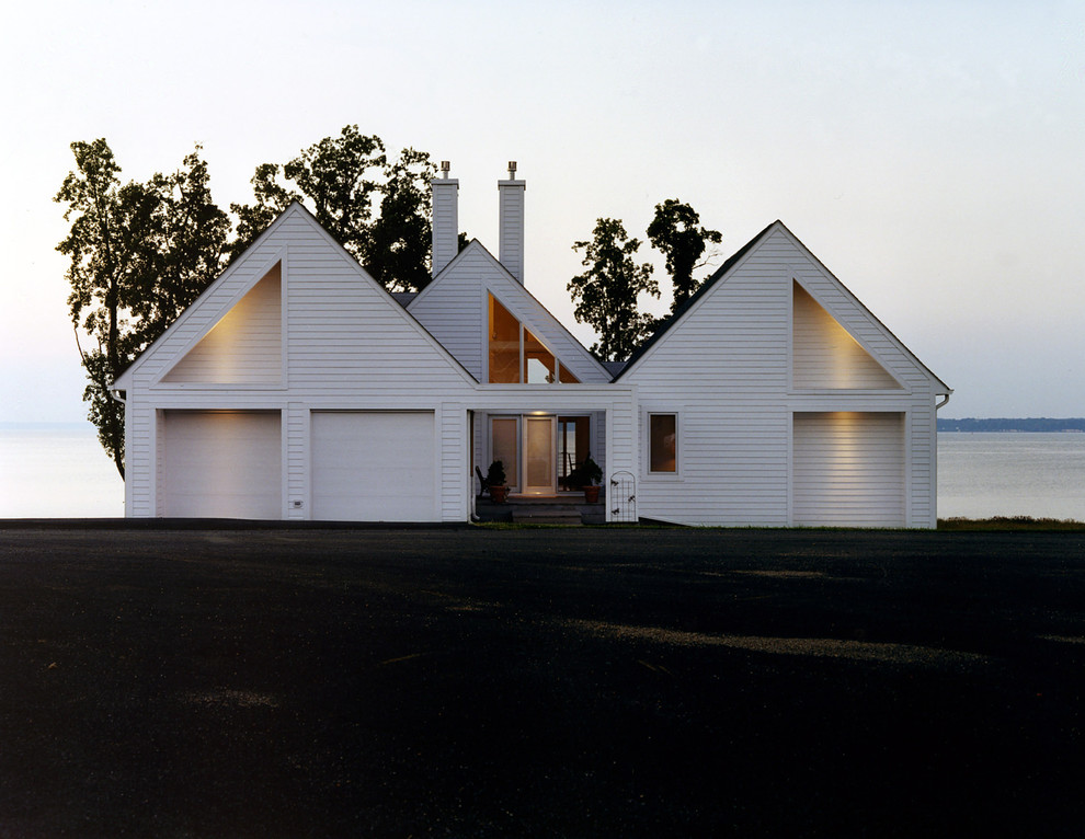 Immagine della facciata di una casa bianca classica con rivestimento in legno