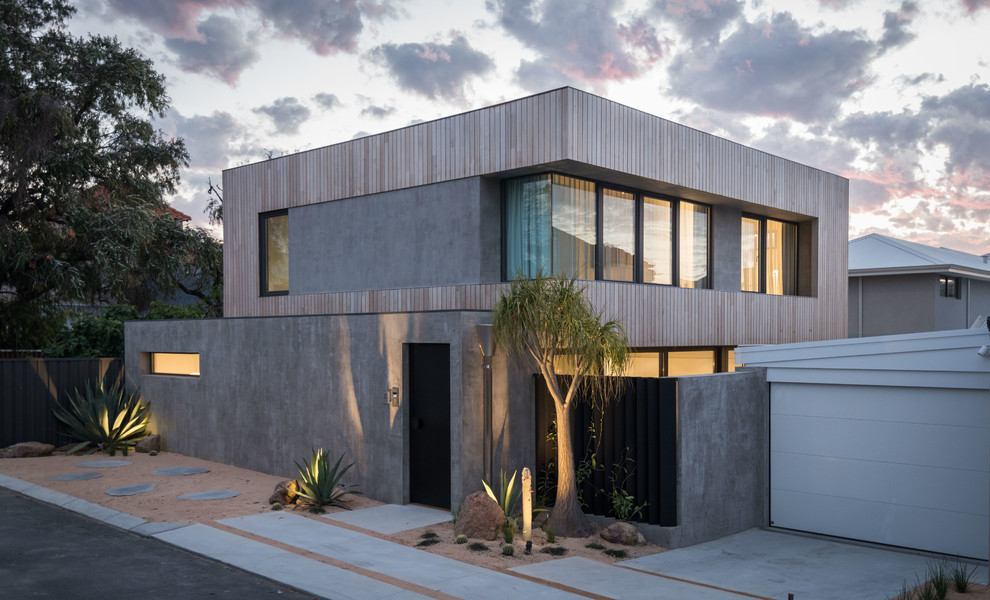Réalisation d'une petite façade de maison grise design à un étage avec un revêtement mixte et un toit plat.