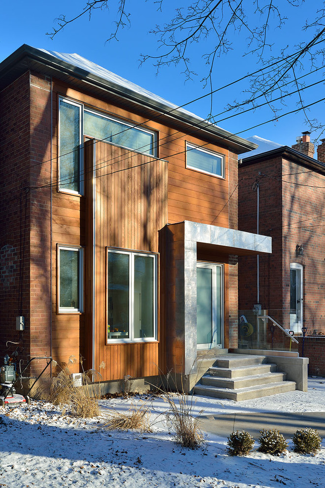Photo of a contemporary brick house exterior in Toronto.