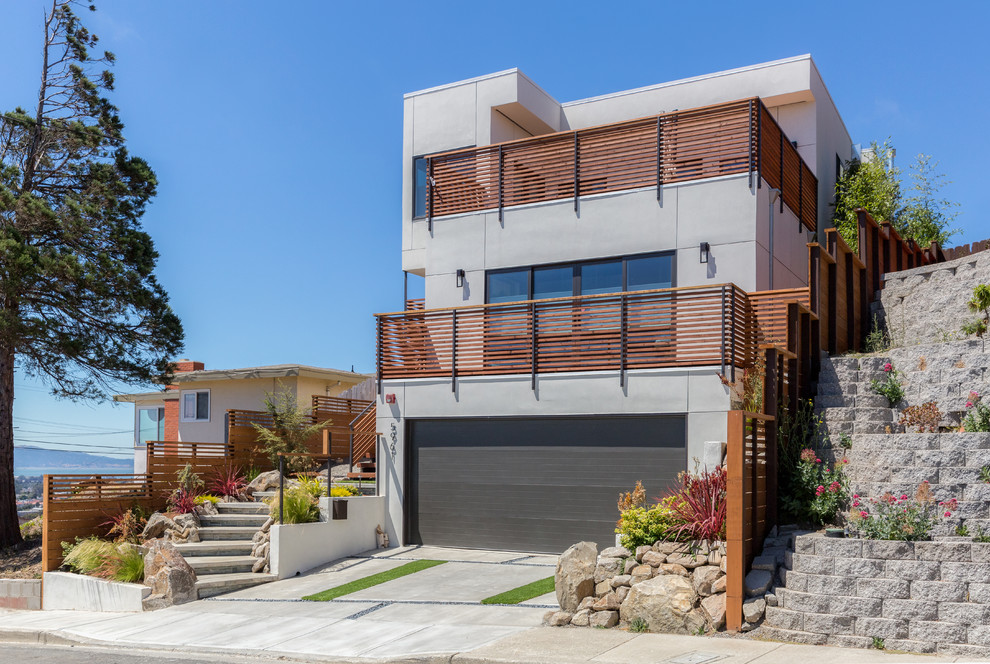 Photo of a gey contemporary house exterior in San Francisco with three floors and a flat roof.