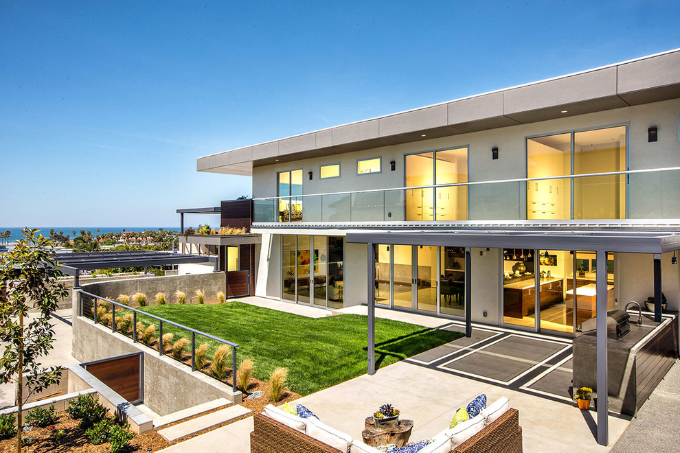 White contemporary two floor glass house exterior in San Diego.