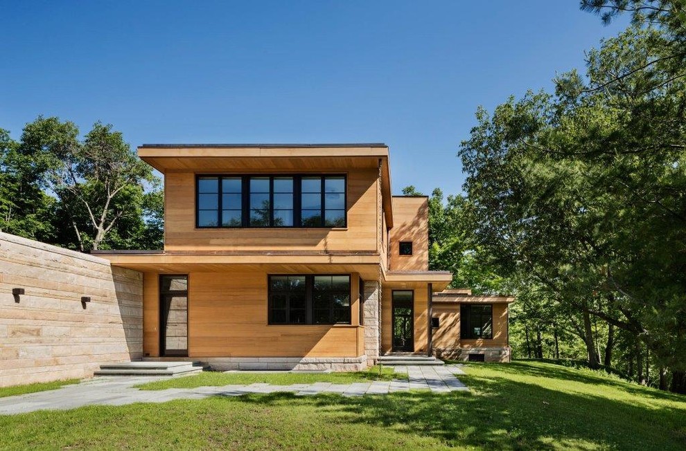 Example of a trendy two-story wood exterior home design in New York