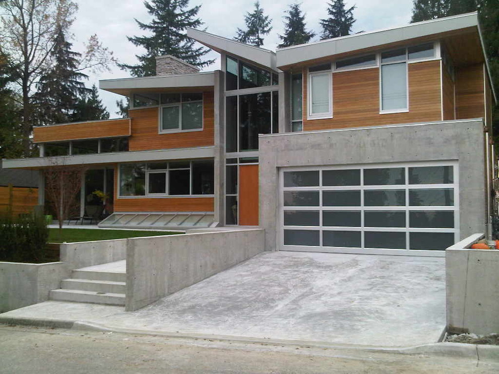 Photo of a contemporary house exterior in Vancouver with wood cladding.