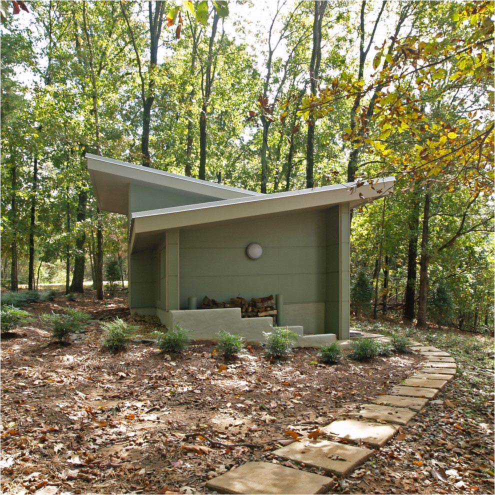 Example of a trendy one-story concrete fiberboard exterior home design in Other with a shed roof