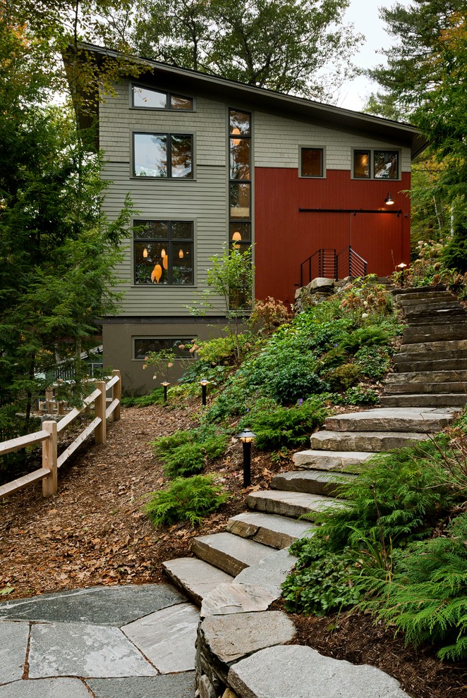 Inspiration for a contemporary house exterior in Burlington with three floors.