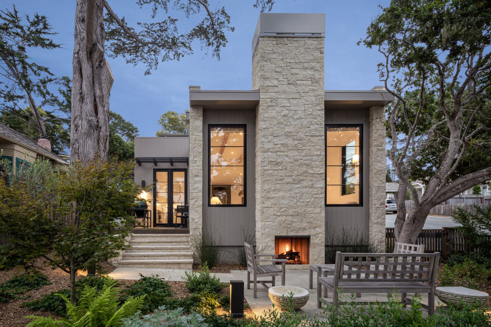 Mid-sized contemporary gray two-story stone exterior home idea in Orange County with a mixed material roof