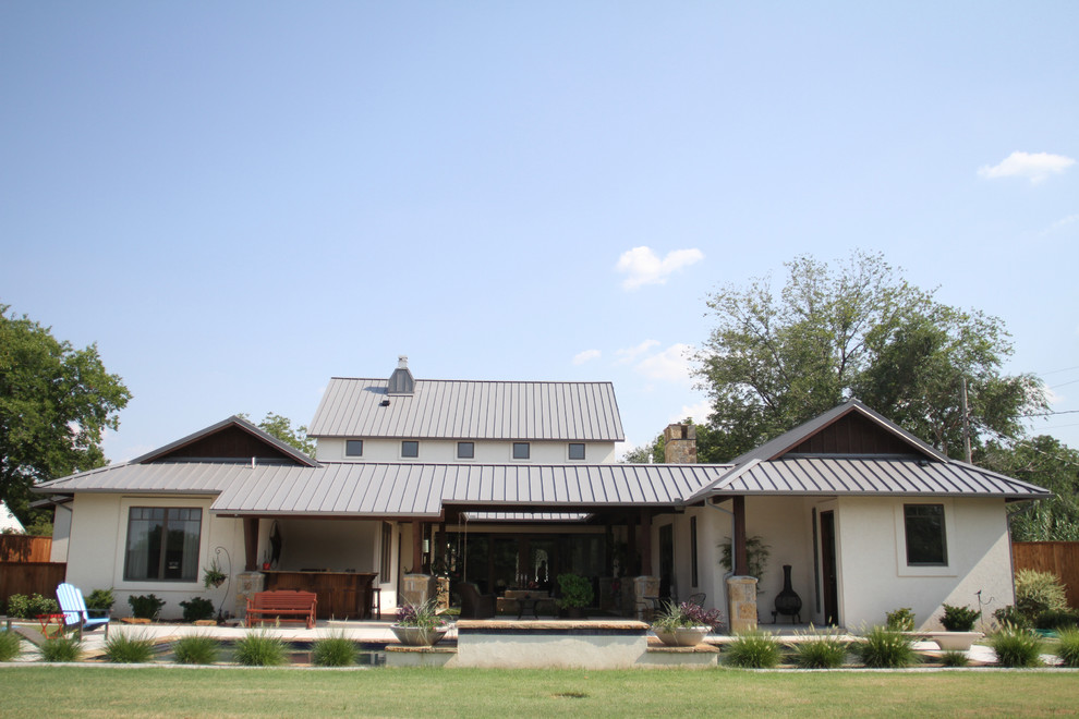 Inspiration for a large eclectic white two-story stucco gable roof remodel in Oklahoma City