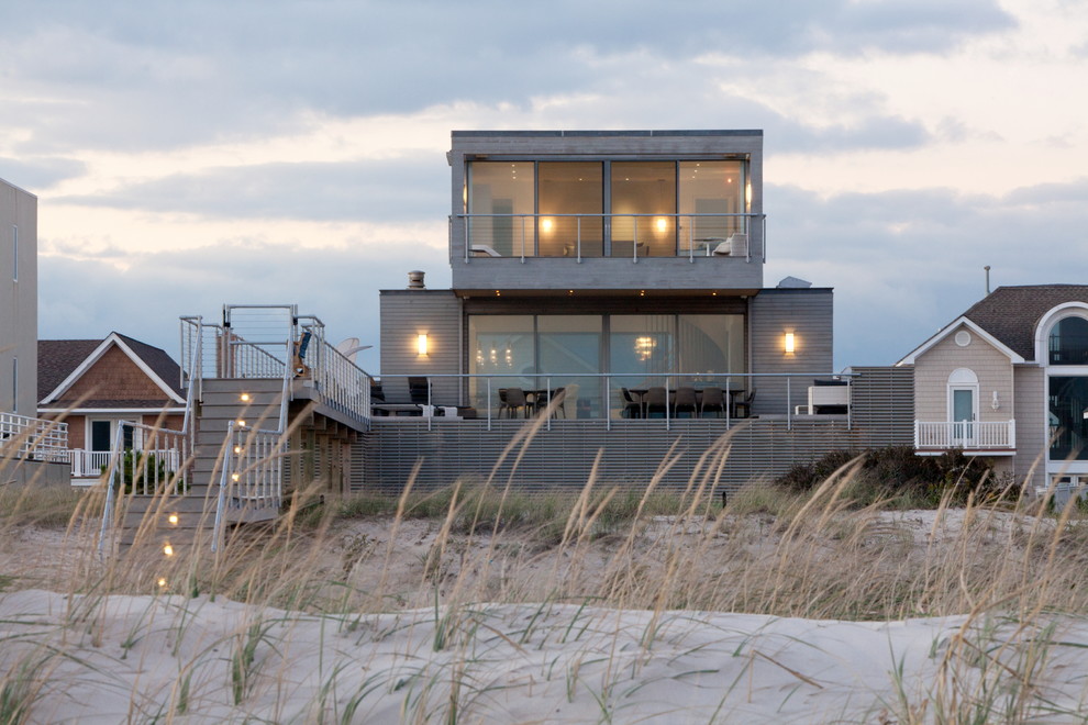 Inspiration for a beach style two floor house exterior in New York with a flat roof.