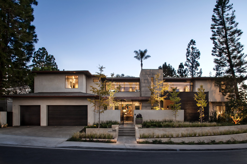 This is an example of a large and white contemporary two floor house exterior in Orange County.