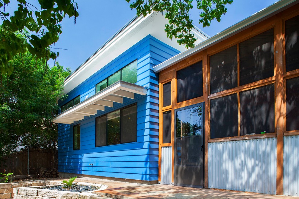 Photo of a blue contemporary house exterior in Austin.