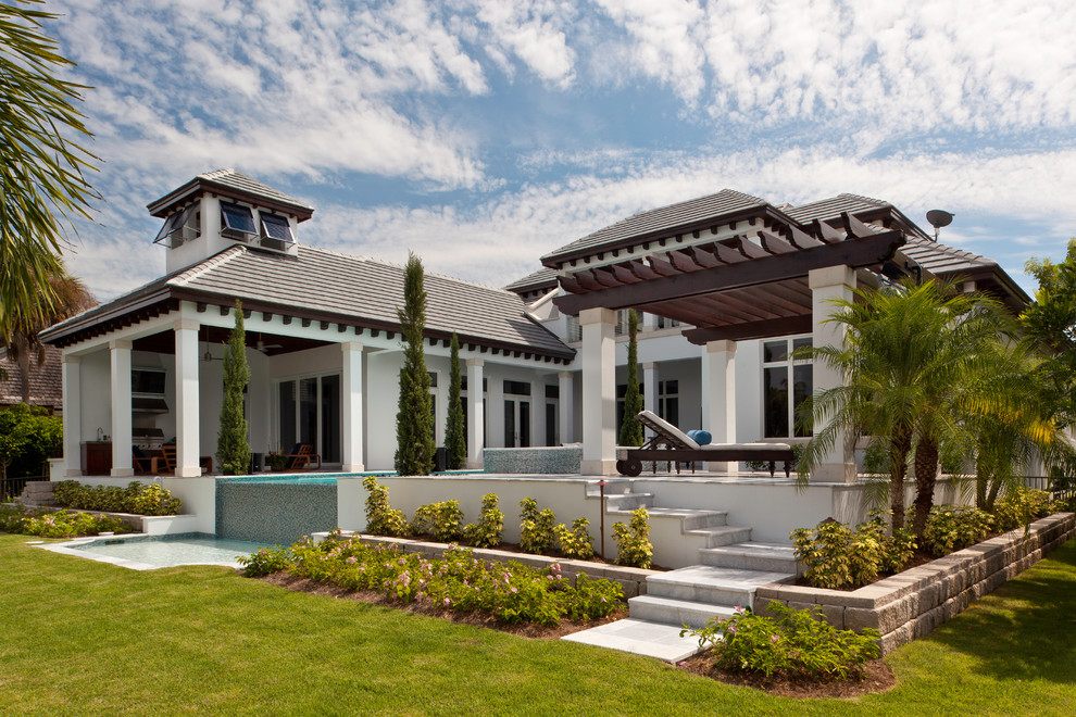 This is an example of a large world-inspired two floor house exterior in Miami.