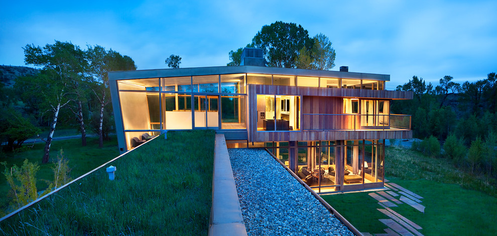 This is an example of a contemporary two floor glass house exterior in Denver.