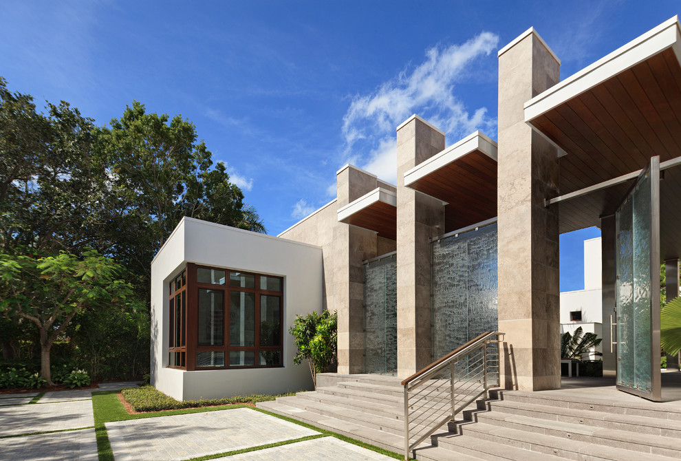 Large and gey contemporary two floor concrete house exterior in Miami.