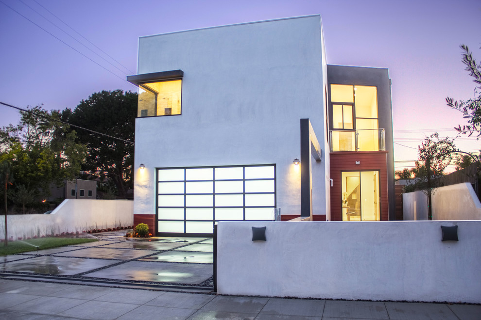 Example of a mid-sized minimalist white two-story stucco exterior home design in Los Angeles