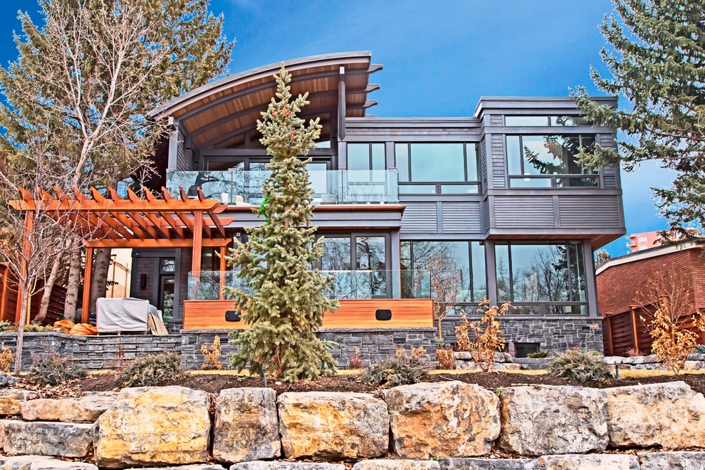 Inspiration for a contemporary gray two-story mixed siding exterior home remodel in Calgary