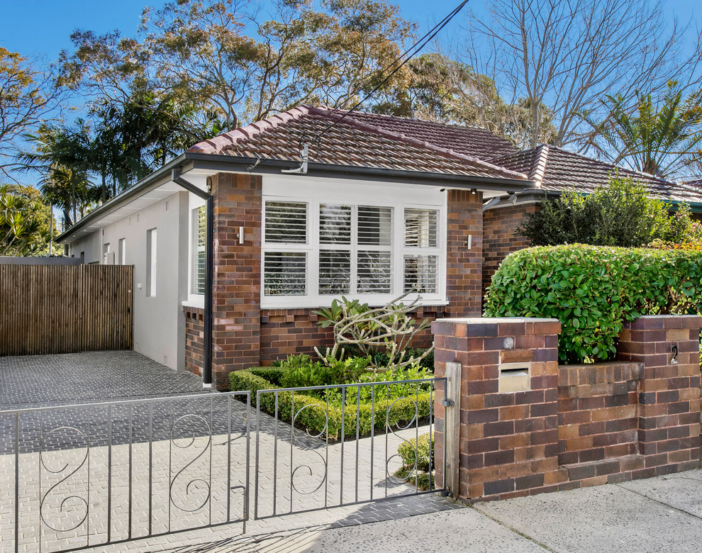 Design ideas for a small and brown traditional bungalow brick detached house in Sydney with a tiled roof and a hip roof.