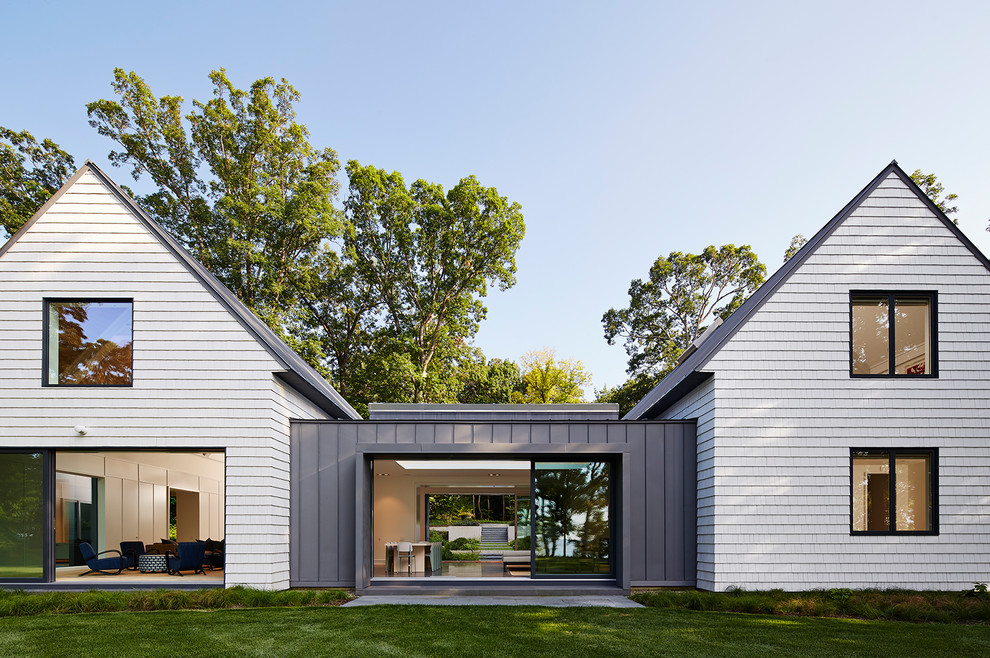 Example of a large cottage multicolored two-story wood exterior home design in Grand Rapids with a metal roof