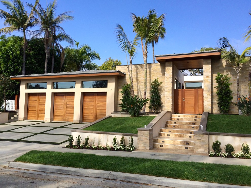 Medium sized and beige world-inspired split-level detached house in Orange County with stone cladding and a flat roof.