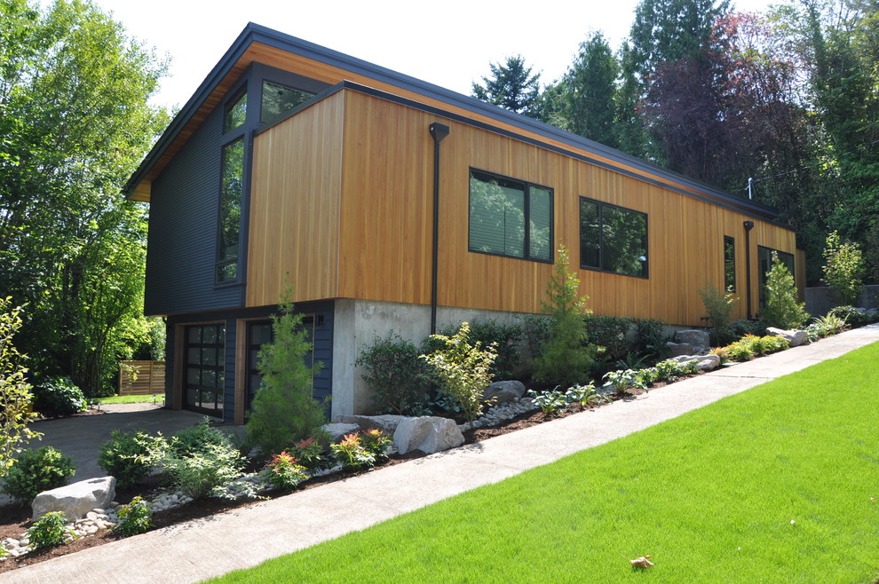 Photo of a contemporary house exterior in Portland with wood cladding.