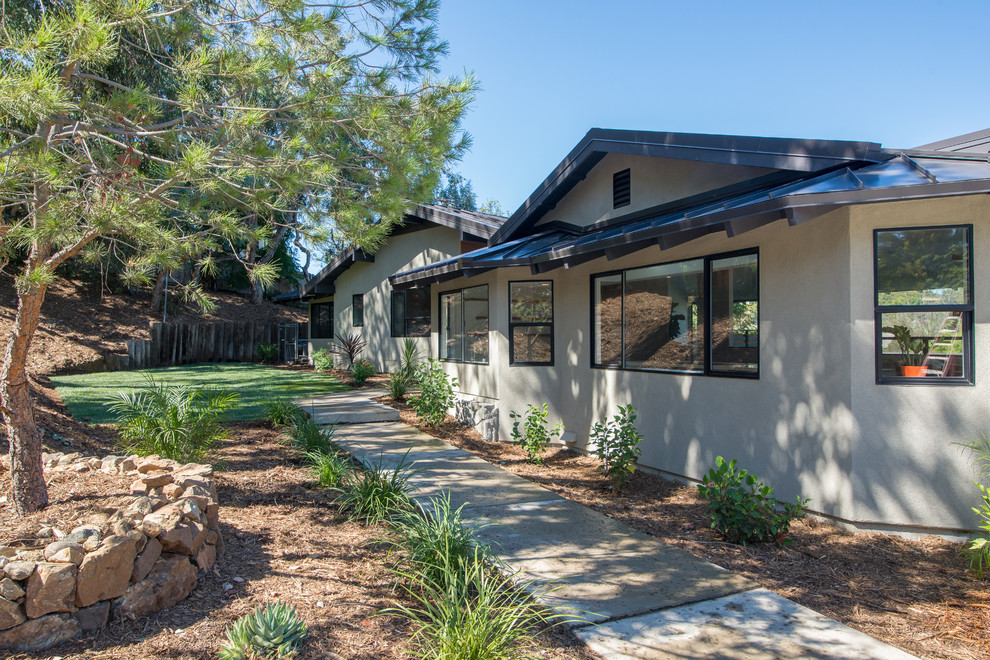 Inspiration for a contemporary gray two-story stucco gable roof remodel in San Diego