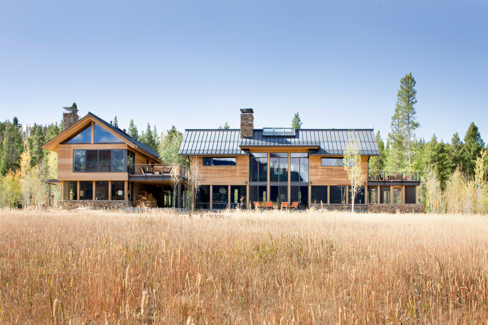 Example of a large minimalist brown two-story mixed siding exterior home design in Denver