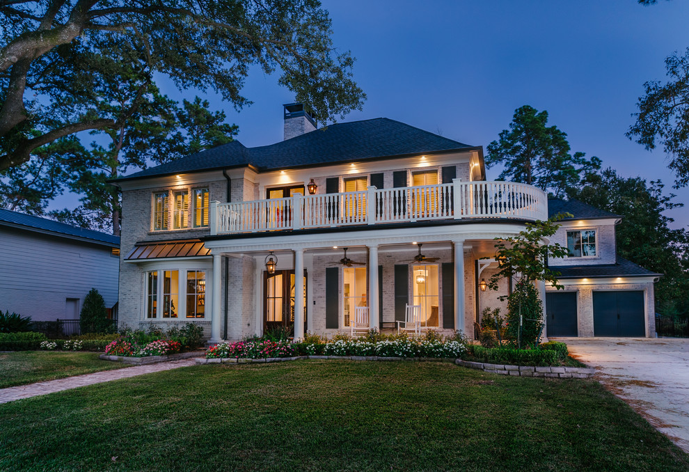 Inspiration for a large and white classic two floor brick house exterior in Houston with a hip roof.